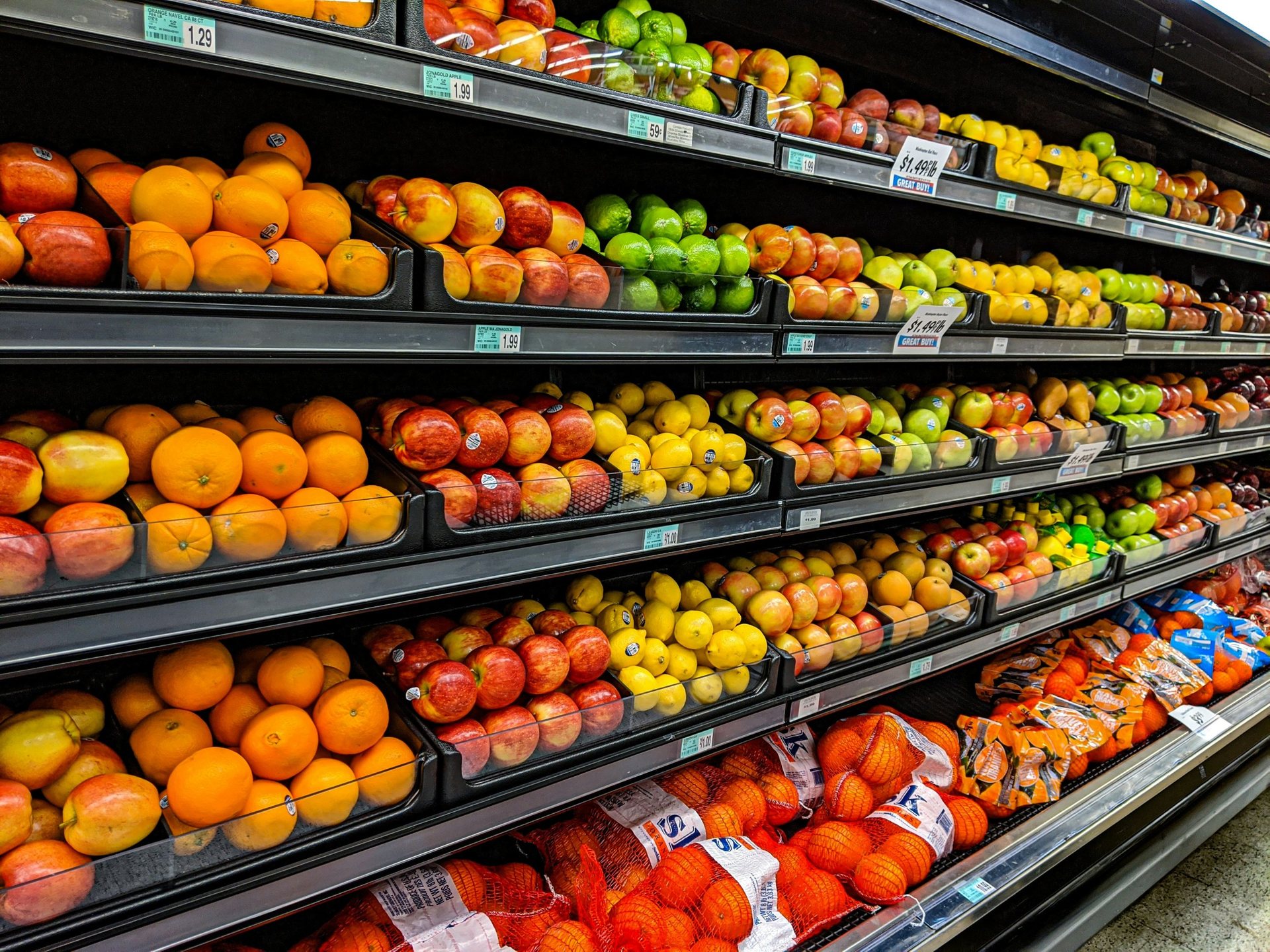 Supermarket produce shelves with fresh fruit
